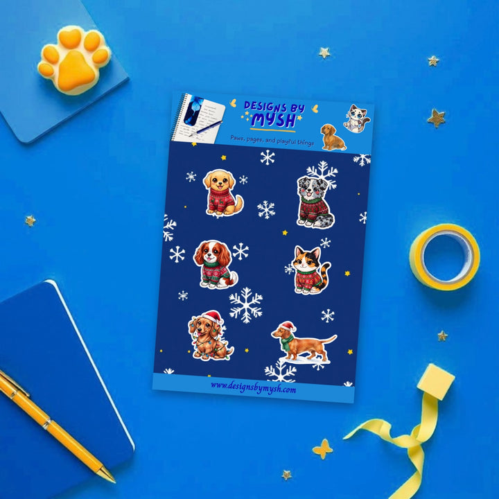 Christmas Pets sticker sheet flat lay with blue and yellow stationery – Designs by Mysh