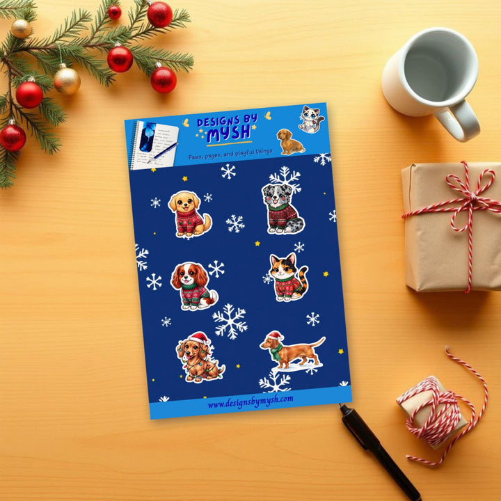 Christmas Pets glossy 4x6 sticker sheet on a holiday wooden desk with pine and ornaments – Designs by Mysh