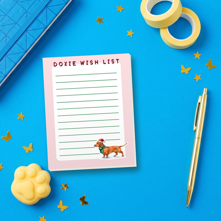 Doxie Wish List notepad flat lay with blue and yellow stationery – Designs by Mysh