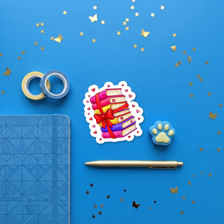 Colorful Book Stack with Bow 3 inch sticker flat lay with blue and yellow stationery – Designs by Mysh