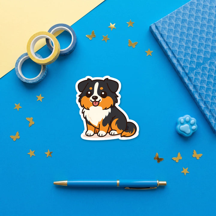 Australian Shepherd Black Tri kawaii 3 inch sticker flat lay with blue and yellow stationery – Designs by Mysh
