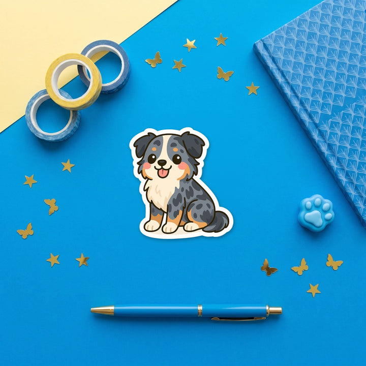 Australian Shepherd Blue Merle kawaii 3 inch sticker flat lay with blue and yellow stationery – Designs by Mysh