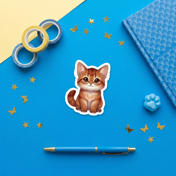 Somali Cinnamon kawaii 3 inch sticker flat lay with blue and yellow stationery – Designs by Mysh