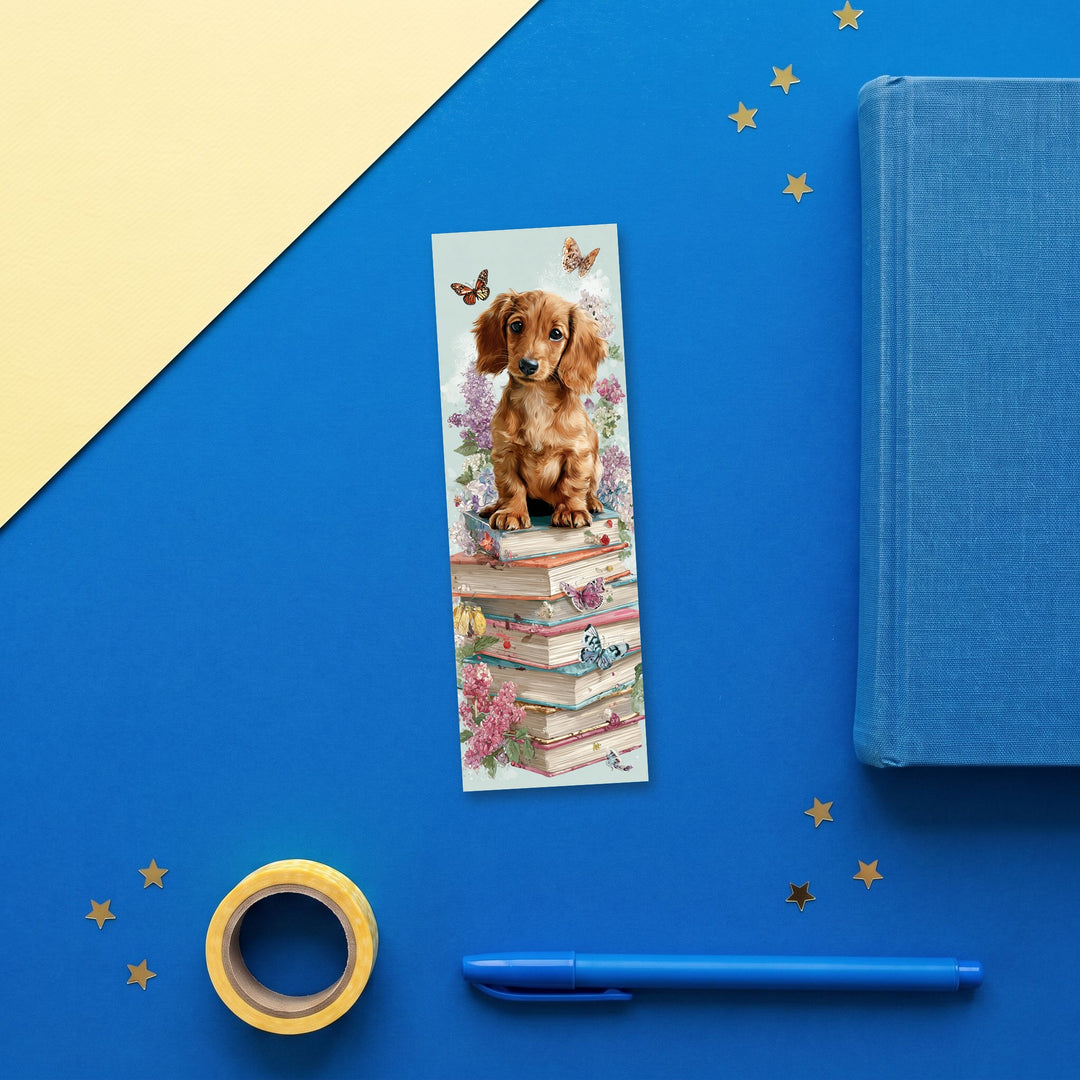 Dachshund on a Bookstack 2x6 inch bookmark flat lay with blue and yellow stationery – Designs by Mysh