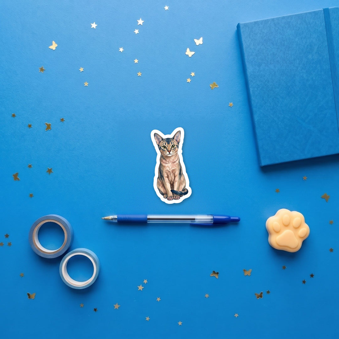 Abyssinian Blue watercolor 3 inch sticker flat lay with blue and yellow stationery – Designs by Mysh