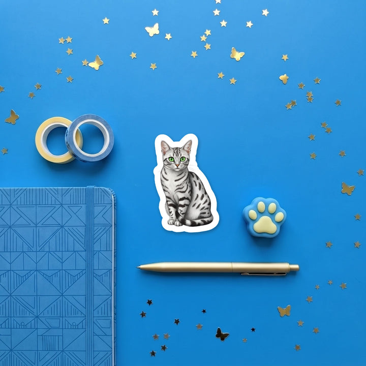 Egyptian Mau Silver watercolor 3 inch sticker flat lay with blue and yellow stationery – Designs by Mysh