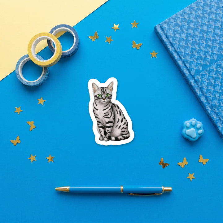 Egyptian Mau Smoke watercolor 3 inch sticker flat lay with blue and yellow stationery – Designs by Mysh