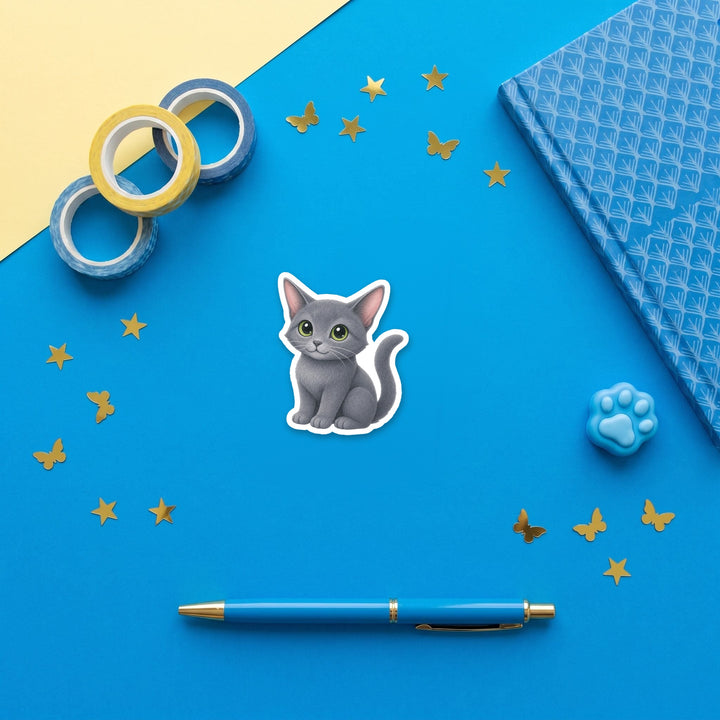 Russian Blue Darkening Blue-Gray kawaii 3 inch sticker flat lay with blue and yellow stationery – Designs by Mysh