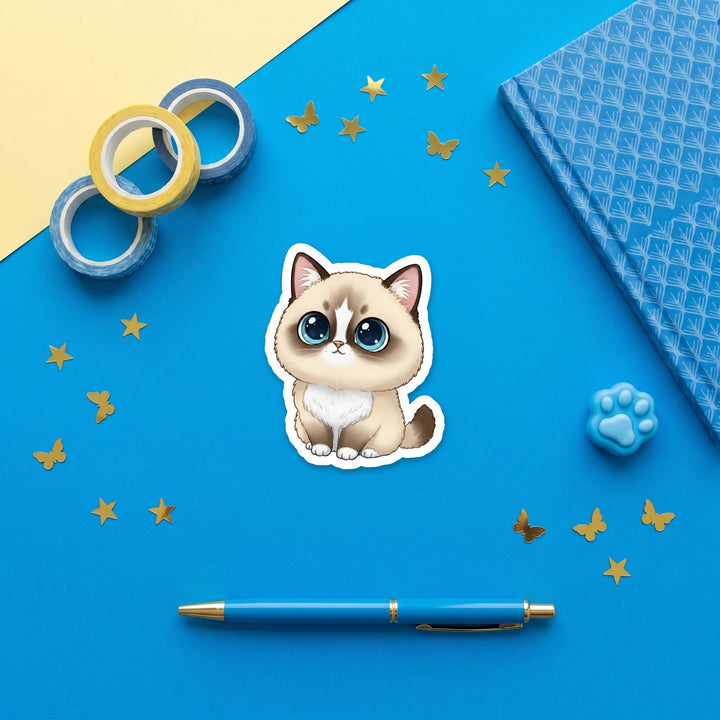 Ragdoll Seal Mitted kawaii 3 inch sticker flat lay with blue and yellow stationery – Designs by Mysh