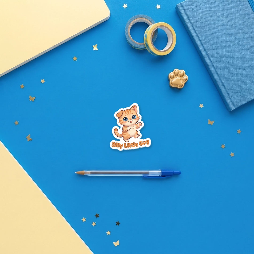 Silly Little Guy 3 inch sticker flat lay with blue and yellow stationery – Designs by Mysh